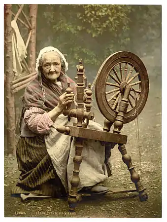 A photochrom of an elderly Irish woman using a spinning wheel, County Galway, Ireland, c. 1890s