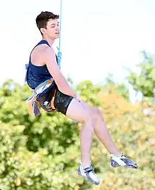 Toby Roberts suspended by a rope at the 2022 European Championships