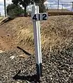 412-kilometre (256&nbsp;mi) sign north of Wellington station
