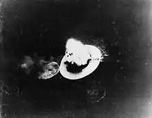 Black and white photo of a large explosion on a body of water