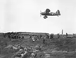 Lysander of No. 13 Squadron provides aiming practice for members of the Home Guard at the Western Command Weapons Training School, Altcar, Lancashire, September 1940.