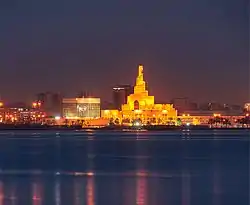The Qatar Central Bank (center, left) and Abdulla Bin Zaid Al Mahmoud Islamic Cultural Center (center, right) as seen from the Doha Corniche promenade.