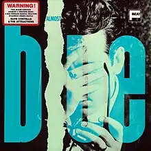 The word "blue" in giant blue letters on top of a man covering his face with his hand.