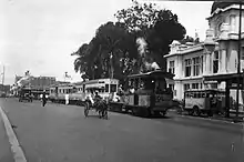 The steam tram in front of the Postspaarbank showing trams for three divided social classes.
