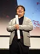 An Asian man in a suit