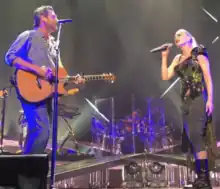 Color picture of singer Gwen Stefani and Blake Shelton performing the aforementioned song live.