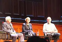 Steggall (centre) on a stage with John Hewson (left) and Peter Garrett (right)