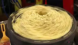 Mung beans being ground to make bindaetteok