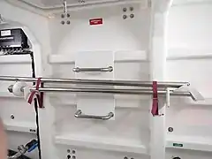 Emergency tiller stowed against transom, emergency exit above