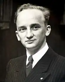 Black-and-white photograph of Ferencz, aged 27, wearing a black pinstriped suit and a dark tie