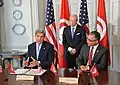 Essebsi oversees a MOU between his adviser Mohsen Marzouk and John Kerry in 2015.