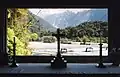 View in 1998 through the central apsidal window of St James' Church, looking across the Waiho River with Franz Josef Glacier visible beyond