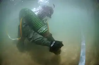 Removing sediment with a suction pump