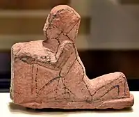 Unfinished figurine of a kneeling Egyptian pharaoh holding a table. From Amarna, House P47.1, Room 5. Neues Museum, Berlin