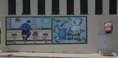 A Norman Rockwell painting on the side of Byrd Drugs in downtown Troy