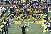 2009 team enters Stadium under the M Club banner to a Michigan Marching Band salute