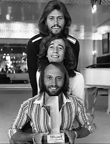 The Bee Gees in 1977 (top to bottom): Barry, Robin, and Maurice Gibb