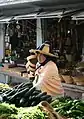 Berber woman selling produce at a Moroccan market