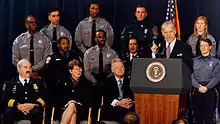 Photo of Senator Biden giving a speech, with uniformed law enforcement officers in the background