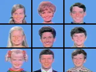 A 3&nbsp;×&nbsp;3 grid of squares with face shots of all nine starring characters of the television series: three blond girls in the left three squares, three brown-haired boys in the right three squares, and the middle three squares feature a blond, motherly woman, a dark-haired woman, and a brown-haired man; all the faces are on blue backgrounds.