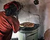 Woman cooking bread on an electric stove