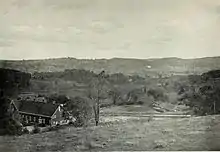 A valley with a barn and pastures