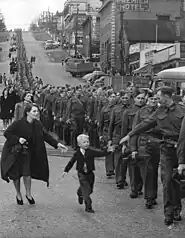 The BC Regiment marching in New Westminster, 1940. This image is called "Wait for me daddy".