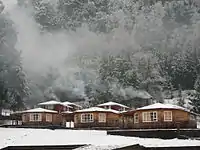 Snow-covered cottages near Curarrehue, Chile