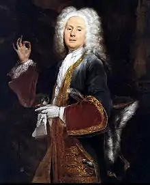 Interior scene of a young Cibber in fine 17th century clothes, richly embroidered, wearing a full wig, holding up a pinch of snuff in his right hand between thumb and forefinger, with the snuffbox and handkerchief in his left hand.