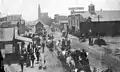 Colorado Boulevard in 1890, then named Colorado Street. Looking east to Marengo Avenue. Horse-drawn wagons displaying America flags, maybe a July 4 parade.