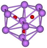 The ball-and-stick diagram shows three regular octahedra where each octahedron is connected to both of the others by one face each. All three octahedra have one edge in common. All eleven vertices of the structure are violet spheres representing caesium, and at the centre of each octahedron is a small red sphere representing oxygen.