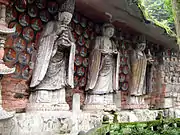 Southern Song Dynasty (1127–1279 CE) cliff carving of Vairocana (centre), with Manjushri (left), and Samantabhadra (right) among the Dazu Rock Carvings at Mount Baoding, Dazu District, Chongqing, China.