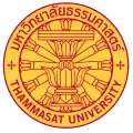 The seal of Thammasat University in Thailand consisting of a Constitution on phan with a twelve-spoked dhammacakka