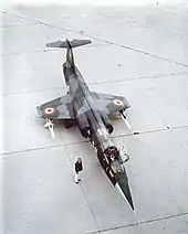 Italian F-104S parked on tarmac with underwing-mounted AIM-7 Sparrow missiles