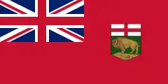 A red flag with a large Union Jack in the upper left corner and a shield, consisting of St. George's Cross over a left-facing bison standing on a rock, on the right side