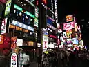 Illuminated signs above a crowded street in Gangnam