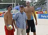 President George W. Bush poses with Todd Rogers and Phil Dalhausser during a practice session in Beijing.