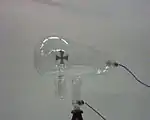 Crookes tube.  The cathode (negative terminal) is on the right.  The anode (positive terminal) is in the base of the tube at bottom.