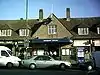 A brown-bricked building with a rectangular, dark blue sign reading "KINGSBURY STATION" in white letters all under a light blue sky