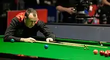 Mark Williams playing a shot with the rest