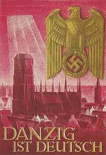 A propaganda poster of a large cathedral with sunlight shining on it. Several buildings can be seen around the cathedral while a left-facing eagle clutching a swastika is seen in the upper right corner of the poster. The words "DANZIG IST DEUTSCH" can be seen in the bottom left of the poster.