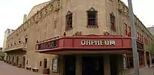 photo of the front entrance of the Orpheum theater, with the red marquee clearly displaying the Orpheum name, contrasted with the pale brown of the stone building