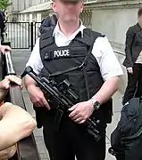 Police officer from Met police London England Uk at Downing Street security holding an MP5A3.