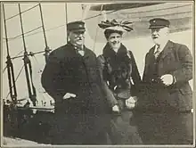 Grover Cleveland, Frances Cleveland, and Elisa Benedict stand on the deck of a boat