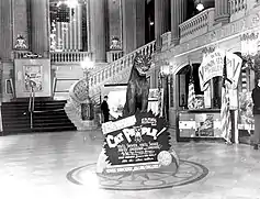 A lobby display with a fake panther a sign reading Cat People