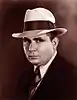 Professional photograph of Robert E. Howard wearing a hat and suit.