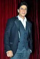 Man standing in blue jacket and vest, without a tie