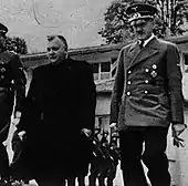 Two men standing, facing the camera