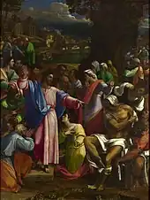 Realistic painting of a robed figure, arms extended, standing outside on a small platform among people doing various things such as talking to each other, but most of whom are looking at him.
