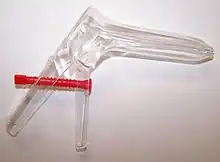 Photograph of a transparent speculum on a white surface